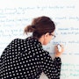 Women at a whiteboard underlining a word