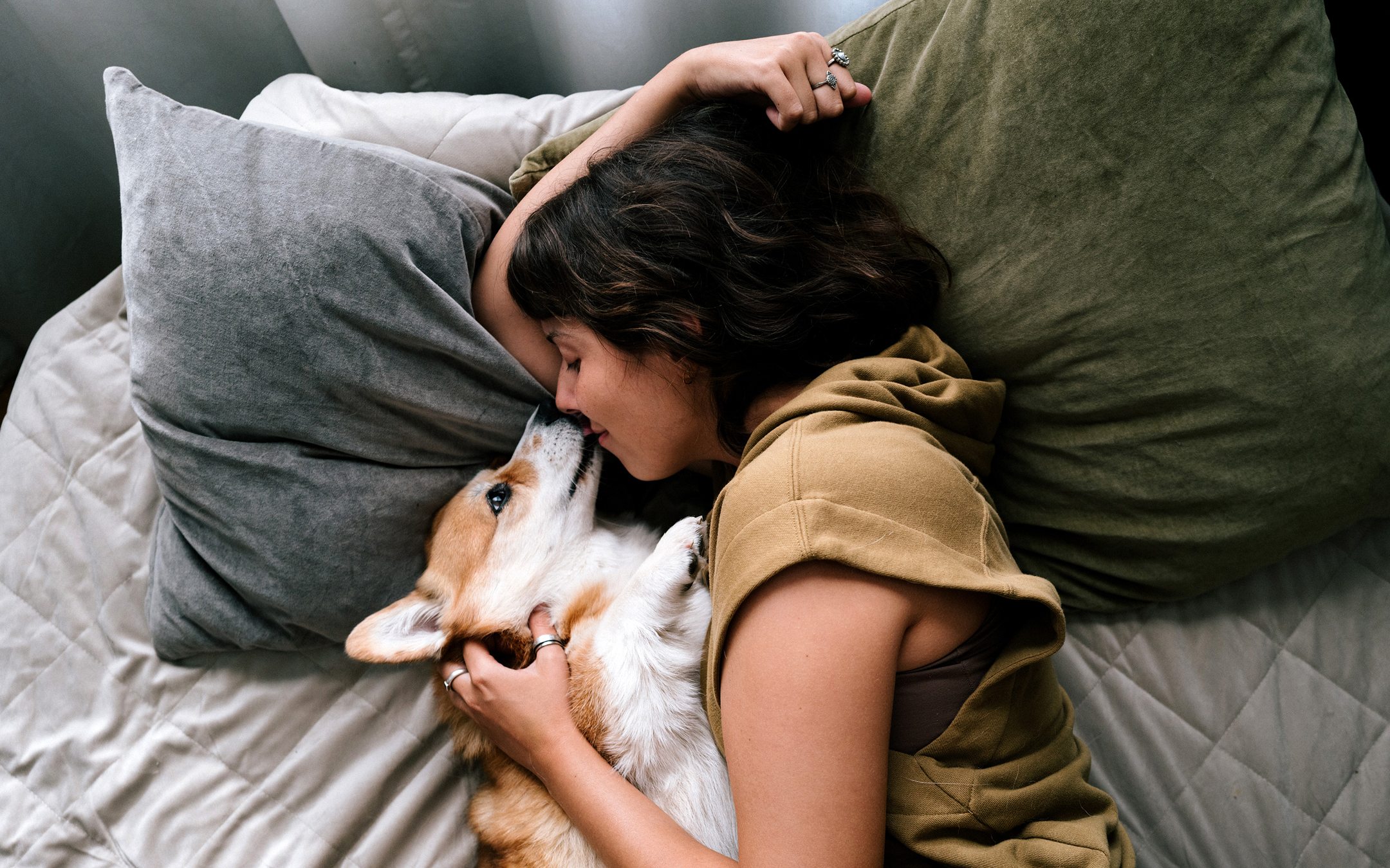 Dog and a lady lying on a bed