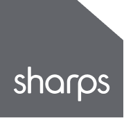 Sharps logo in white text on dark gray background with angular corner design