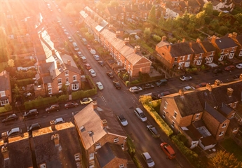 An aerial view of a crossroads showing multiple houses in the street