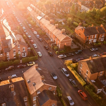 An aerial view of a crossroads showing multiple houses in the street